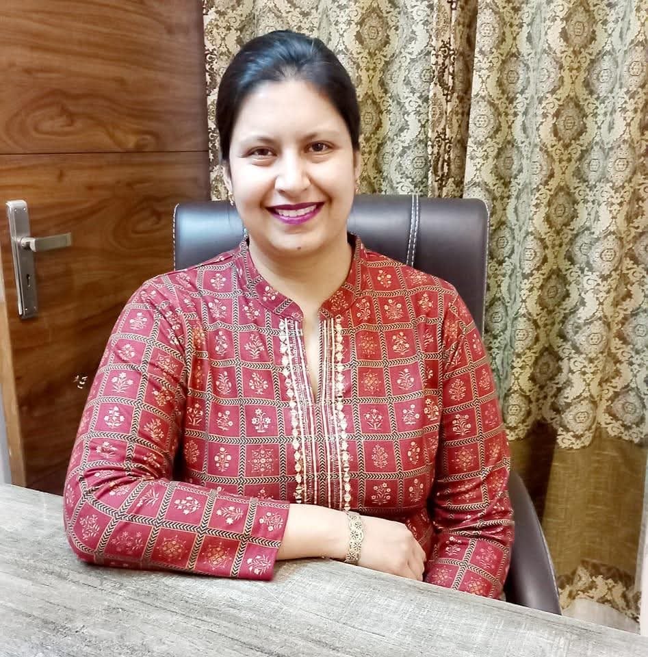 Dr. Neha Mittal — MPT (Neurology) — Gold Medalist, BPT, MIAP seated at her desk